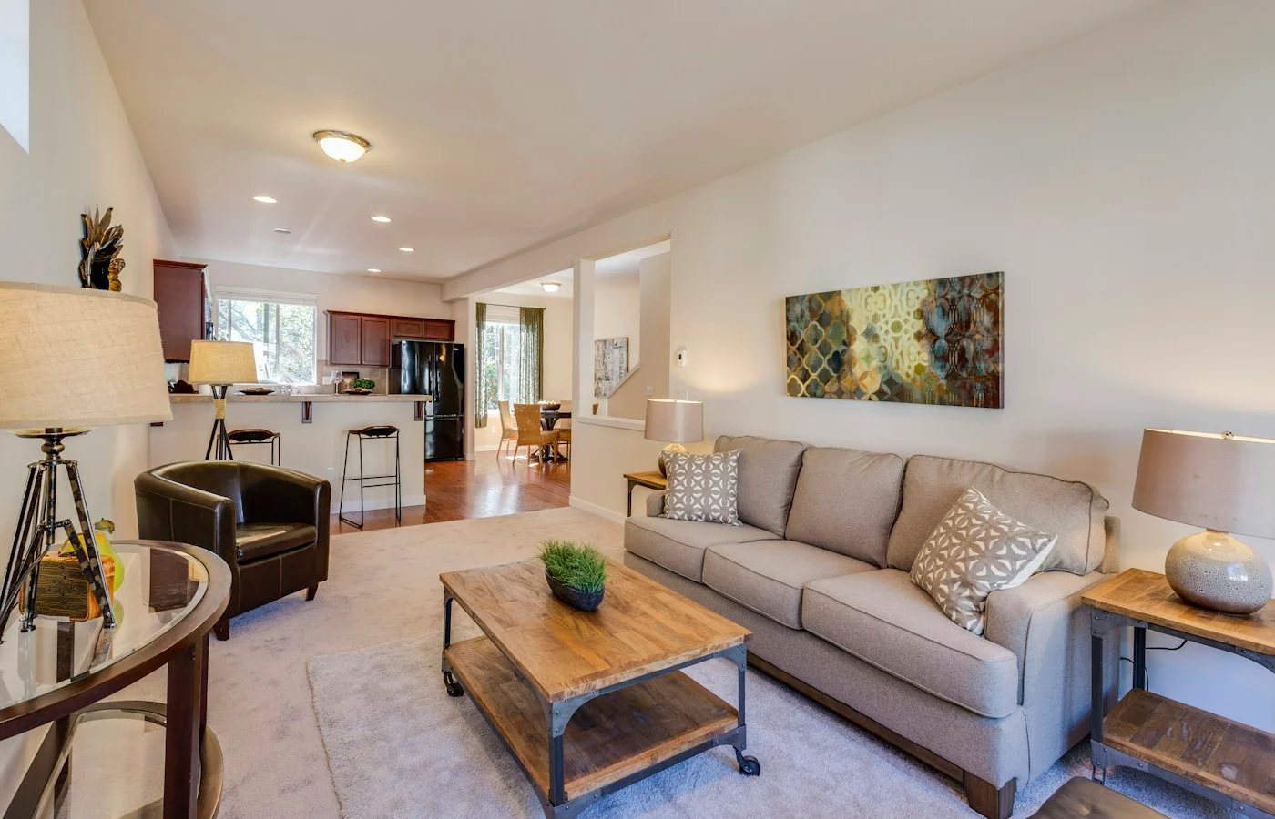 A bright living room opening onto a kitchen and dining area